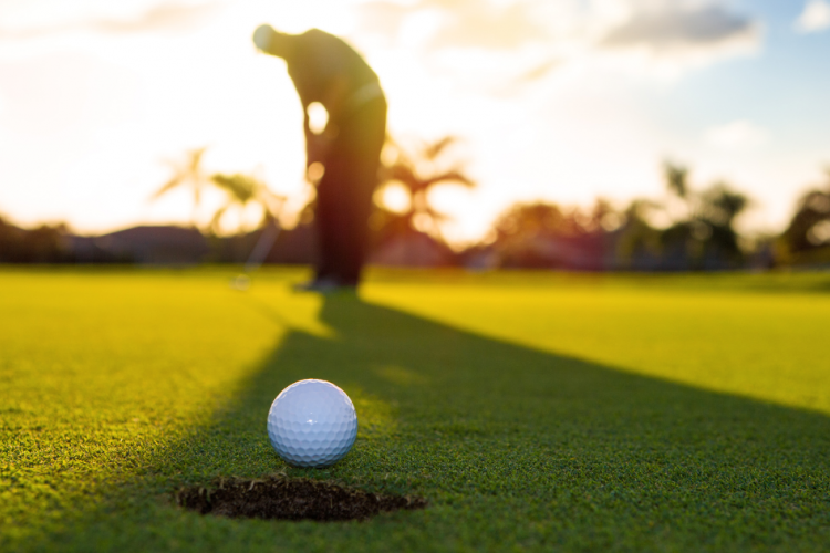golfer putting on golf course